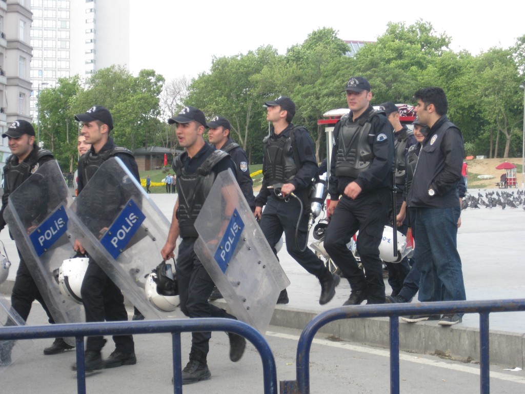 Behind the blockades at Taksim Square, cops toting riot shields and tear gas